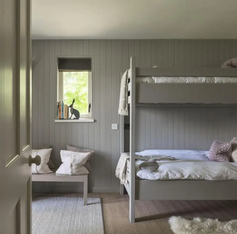 a bedroom with two bunk beds and a window at New Brachkashie Cottage in Whitebridge