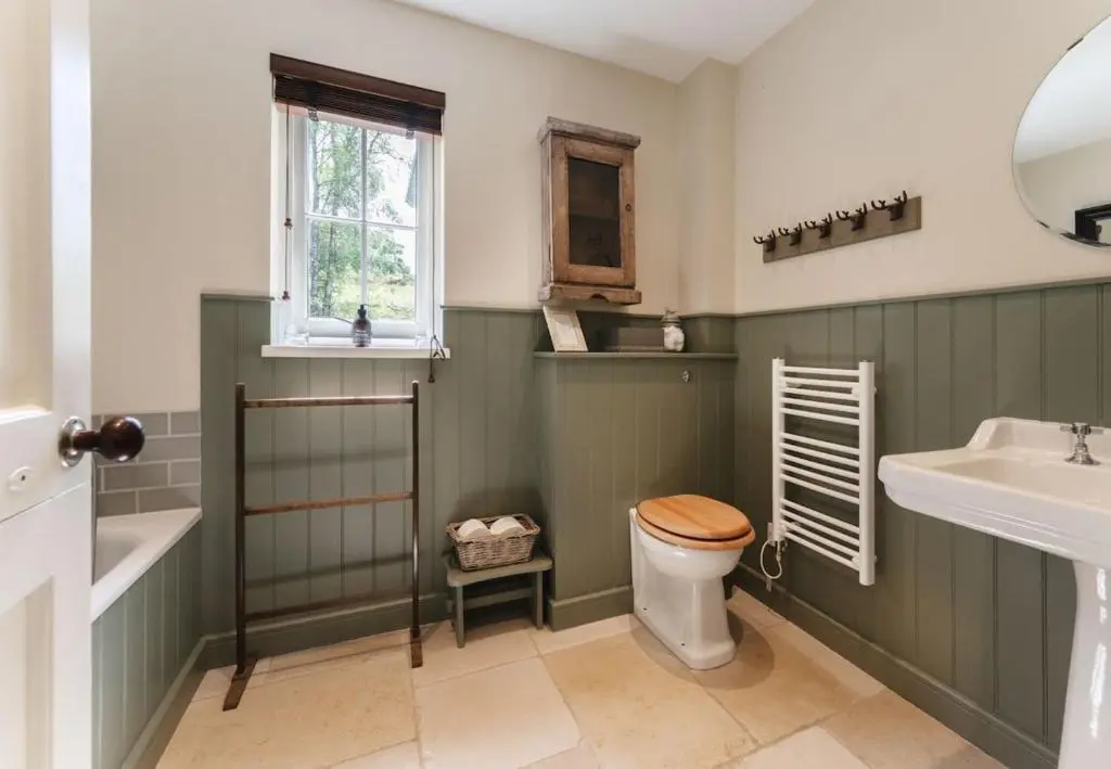 a bathroom with a toilet and a sink at New Brachkashie Cottage in Whitebridge
