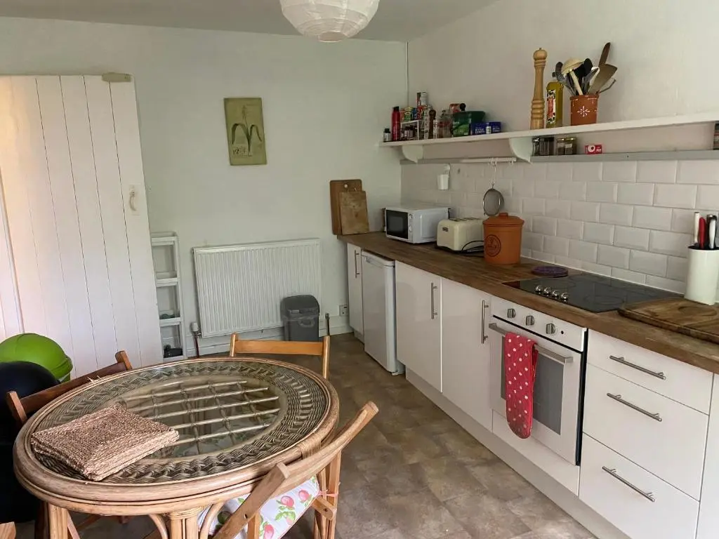 a kitchen with a table and a counter top at Kirkton Cottage whole house in Cairnie Aberdeenshire in Rothiemay Station