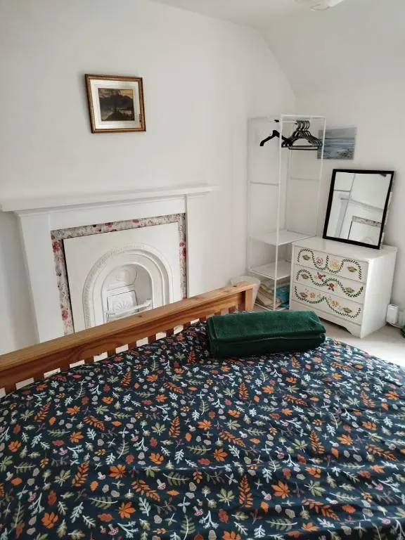 a bedroom with a large bed with a fireplace at Kirkton Cottage whole house in Cairnie Aberdeenshire in Rothiemay Station