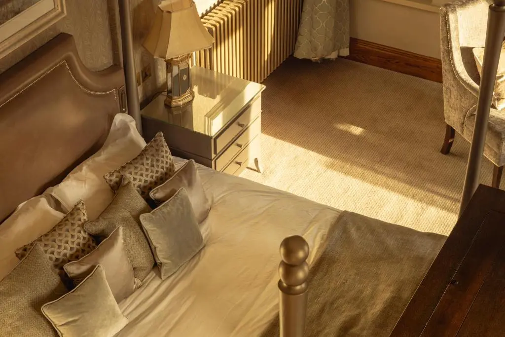 a bedroom with a white bed with pillows at The Station Hotel in Rothes
