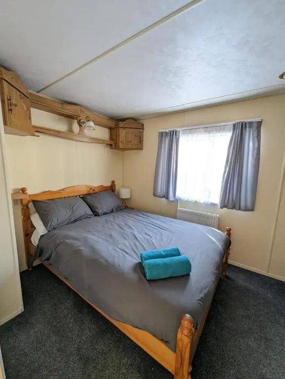 a bedroom with a bed in a small room at Highland getaway in kingussie golf club in Kingussie