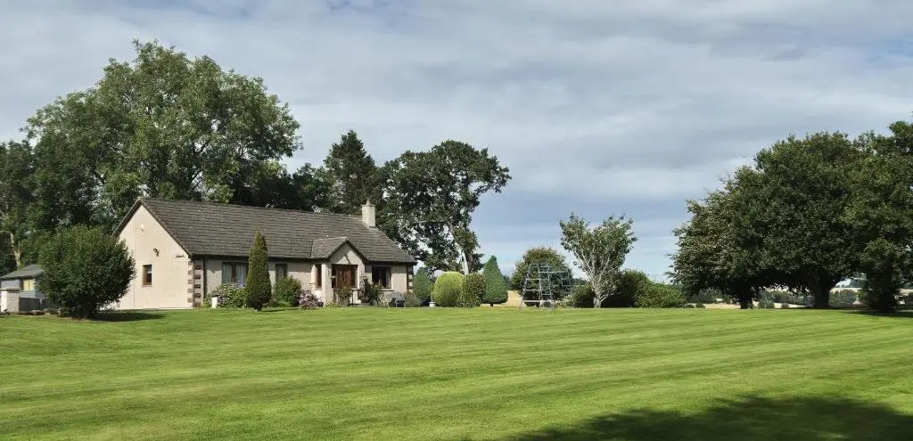 a house on a large grassy field at Dail Daraich in Munlochy