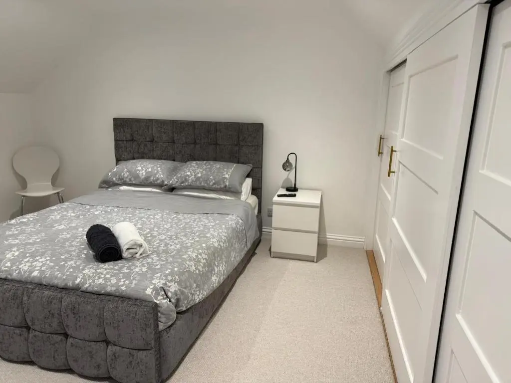 a bedroom with a large bed and a night stand at Halfred House in Wick