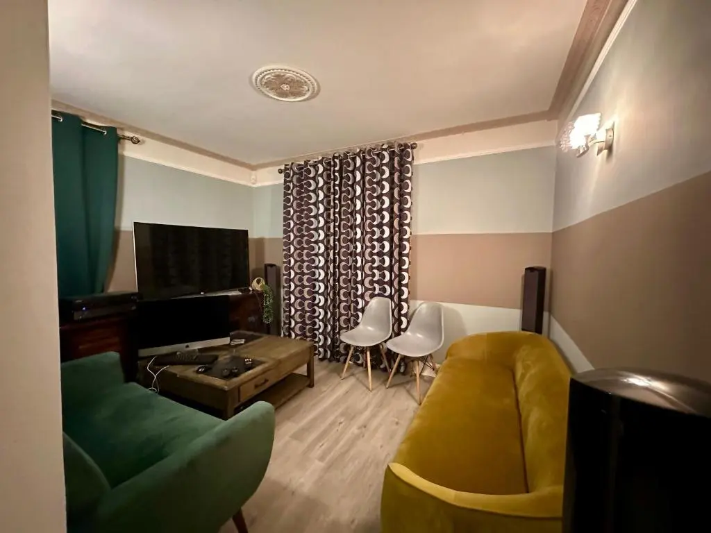 a living room with a couch and a table at 3 Bed Cottage Sleeps 2 with Parking Garden & Wifi in Aberdeen