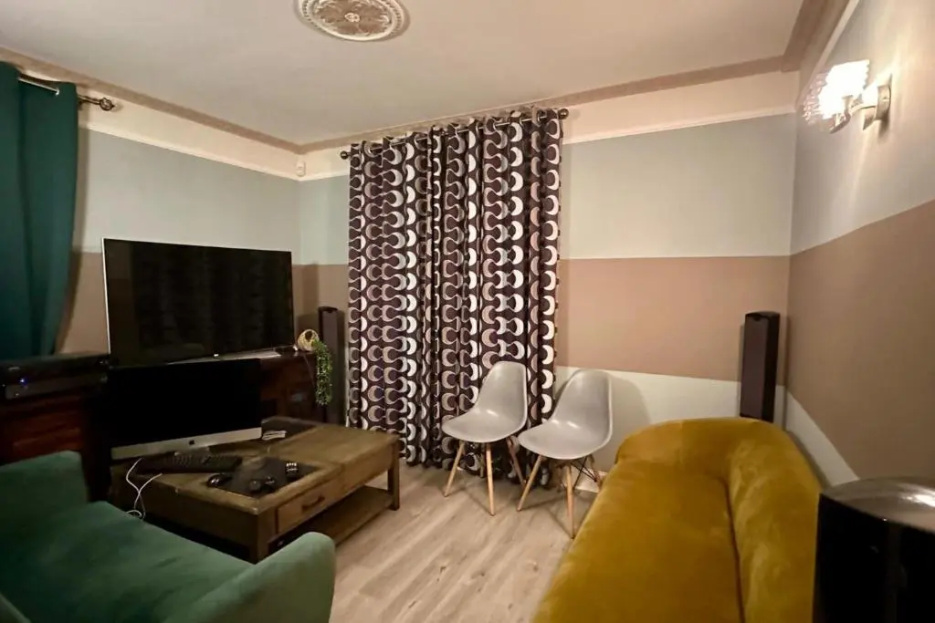 a living room with a couch and a table and chairs at 3 Bed Cottage Sleeps 2 with Parking Garden & Wifi in Aberdeen