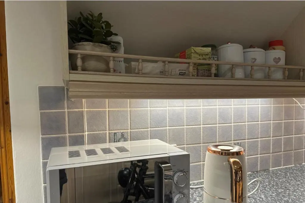 a kitchen with a sink and a counter top at 3 Bed Cottage Sleeps 2 with Parking Garden & Wifi in Aberdeen