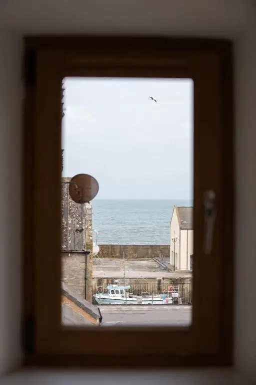 a view of the ocean from a window at Apartment Harbour Nights Deluxe 7E by Interhome in Lossiemouth