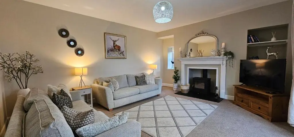 a living room with a couch and a tv at 3 Bed House near Loch Ness in Inverness
