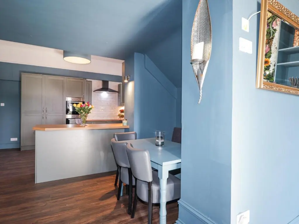 a kitchen and dining room with a table and chairs at Glenspey in Kingussie