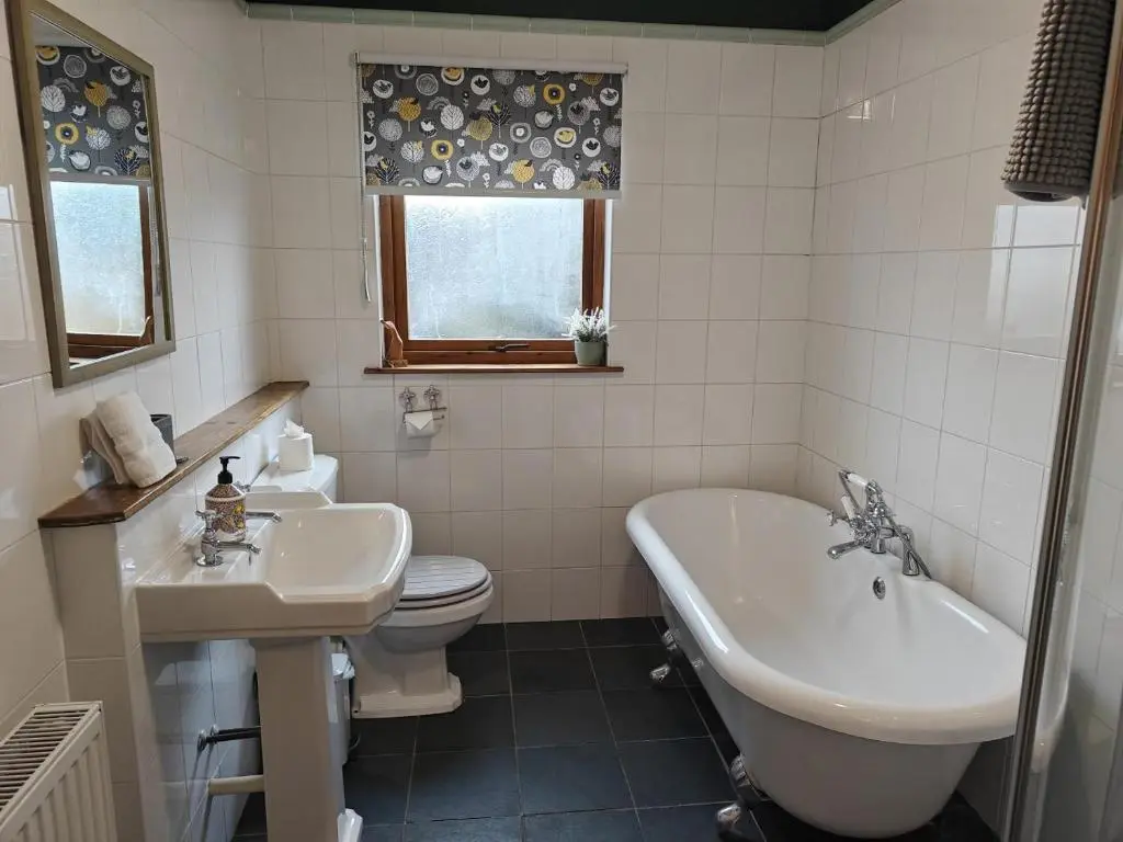 a bathroom with a sink and a tub and a toilet at 3 Bed in Aviemore oc-s30815 in Aviemore