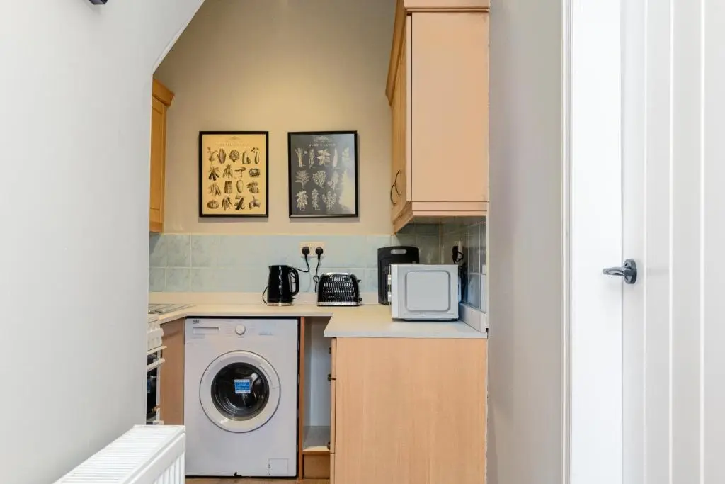 a kitchen with a washer and dryer on a counter at 2 Bedroom Flat - Free Parking - by Holiday Homes in Inverurie