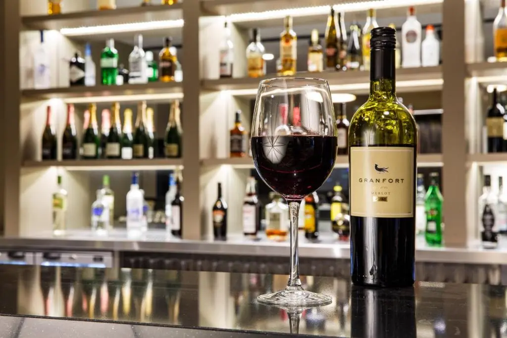 a bottle of wine sitting next to a wine glass at Crowne Plaza Aberdeen Airport by IHG in Dyce