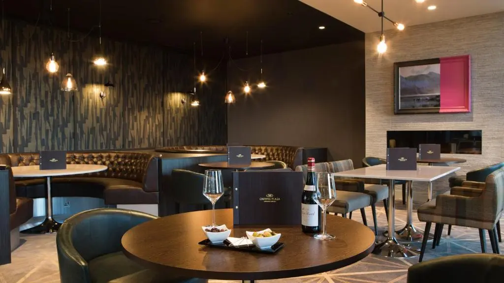 a restaurant with tables and chairs and wine glasses at Crowne Plaza Aberdeen Airport by IHG in Dyce