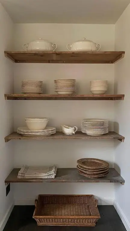 a shelf filled with plates and bowls and dishes at Old school - Charming Historic Cottage for Seven in Ballater