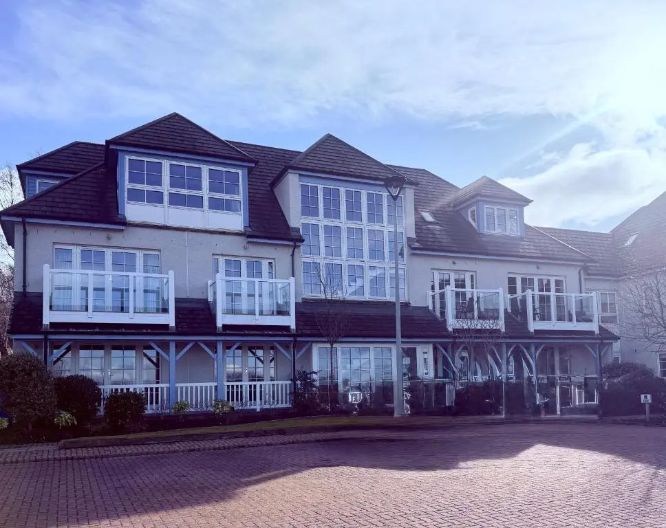 a large house with white windows and a roof at Castlefield Penthouse in Inverness