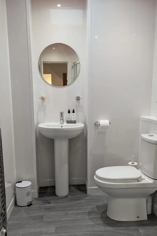 a bathroom with a sink and a toilet and a mirror at The Wee Heilan' Dram in Keith