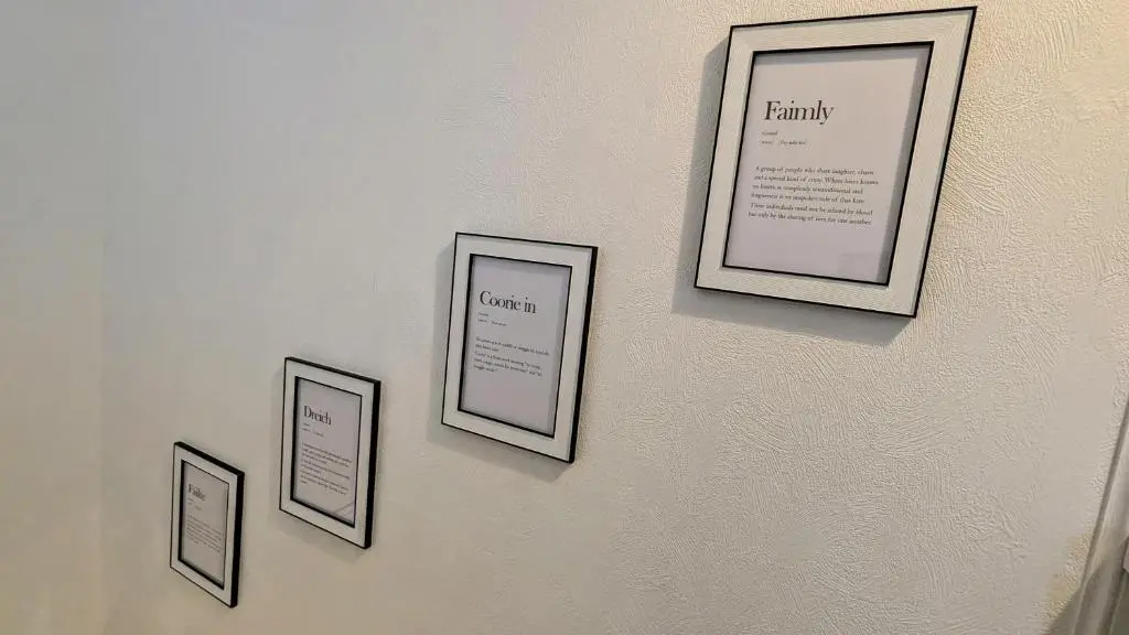a wall with four pictures hanging on a wall at The Wee Heilan' Dram in Keith