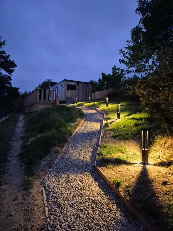a gravel road leading up to a building at Little Getaway in the Highlands, private sauna and stargazing geodome in Garve