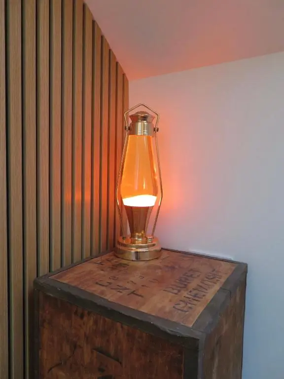 a lantern sitting on top of a wooden table at The Loft at Log Ness in Inverness