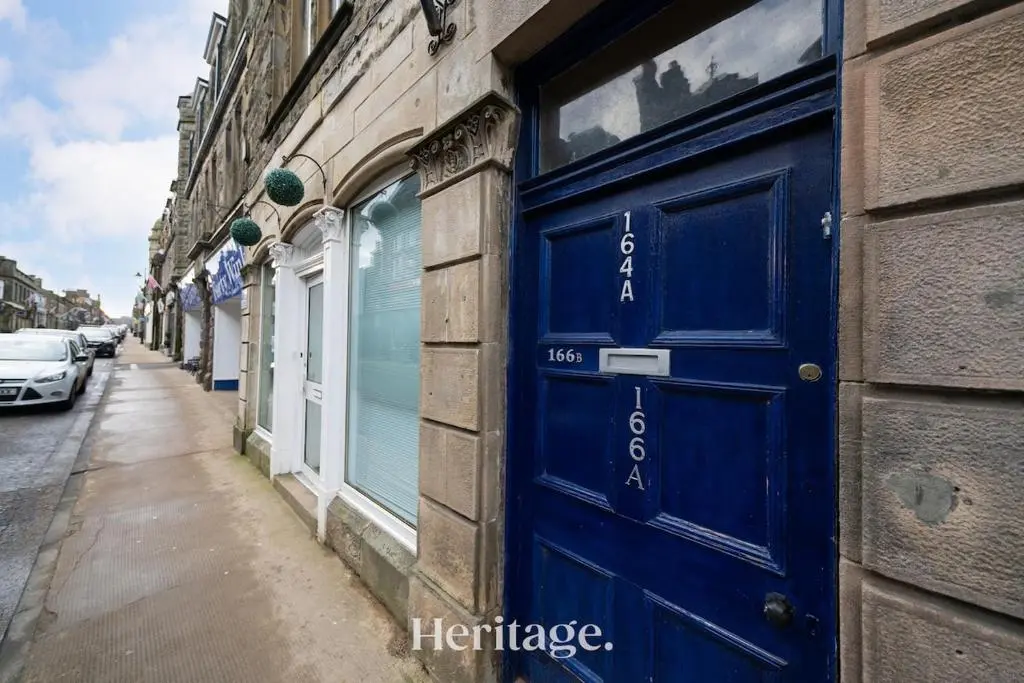 a blue door on the side of a building at The Copper Loft Apartment, Keith in Keith