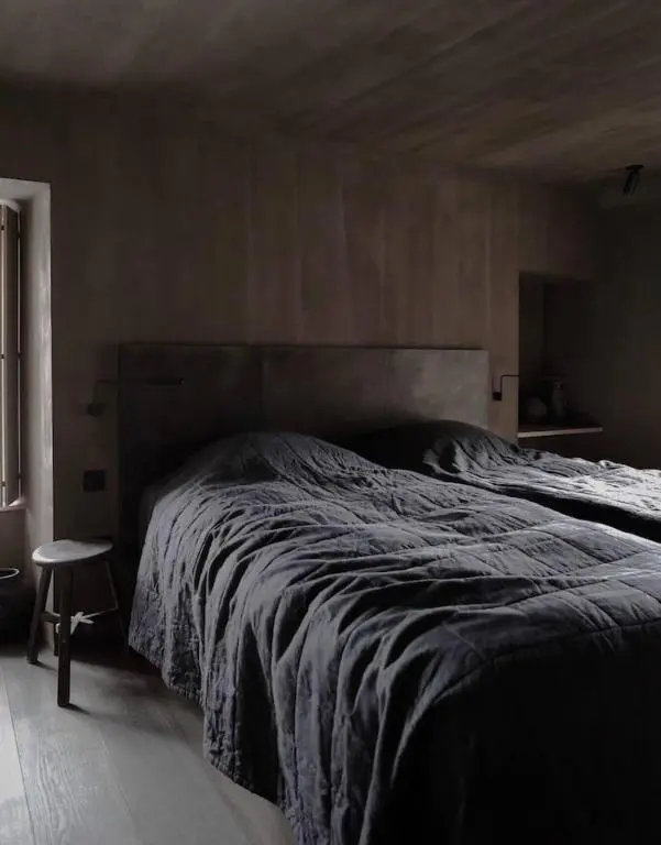 a bedroom with a large bed with a wooden headboard at Luxury lodge for 16 in Royal Deeside in Ballater