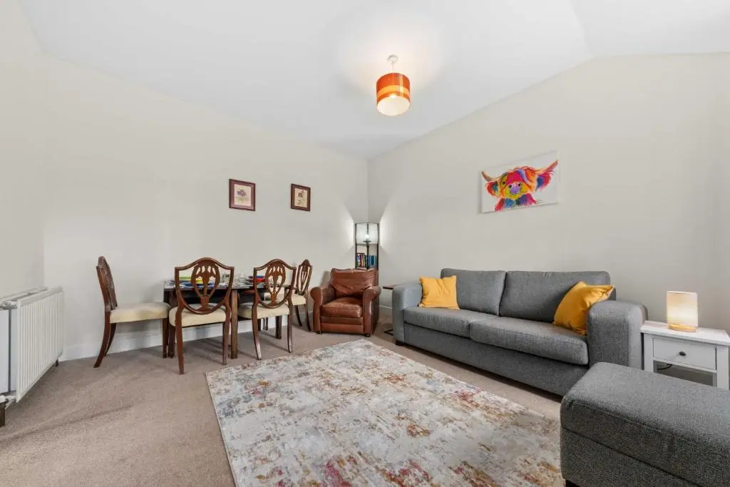 a living room with a couch and a table at Central 1 Bedroom Apartment - Inverness in Inverness