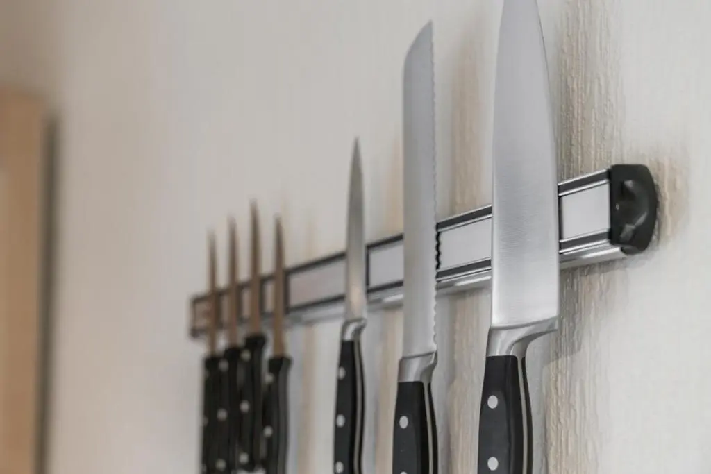 a row of knives hanging on a wall at Central 1 Bedroom Apartment - Inverness in Inverness
