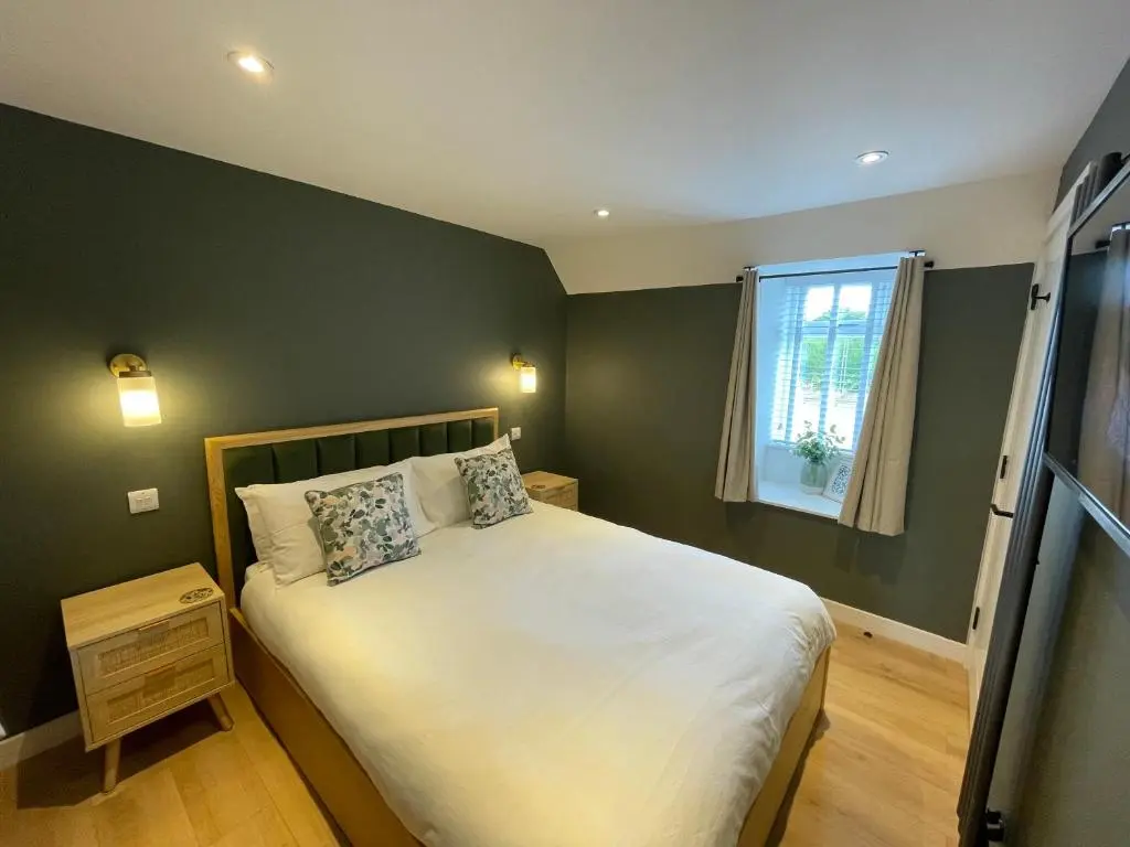 a small bedroom with a bed and a window at Struie Bothy near Dornoch Beach in Dornoch