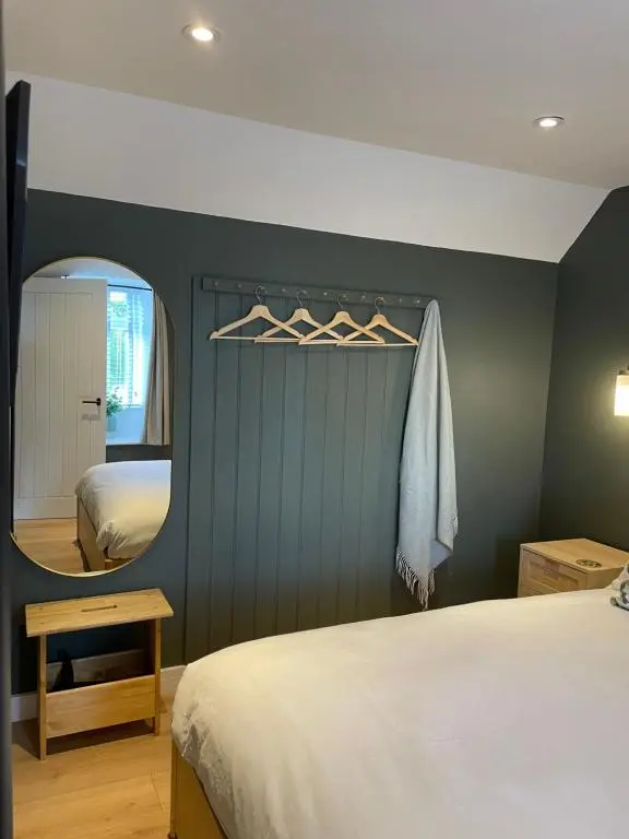 a bedroom with a bed and a mirror at Struie Bothy near Dornoch Beach in Dornoch