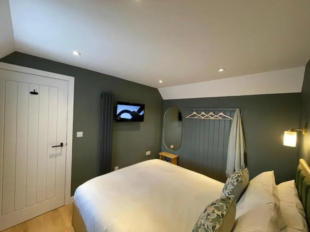a bedroom with a large white bed and a window at Struie Bothy near Dornoch Beach in Dornoch