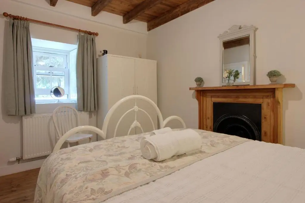 a bedroom with a bed with a towel on it at Bridge Cottage in Glenlivet