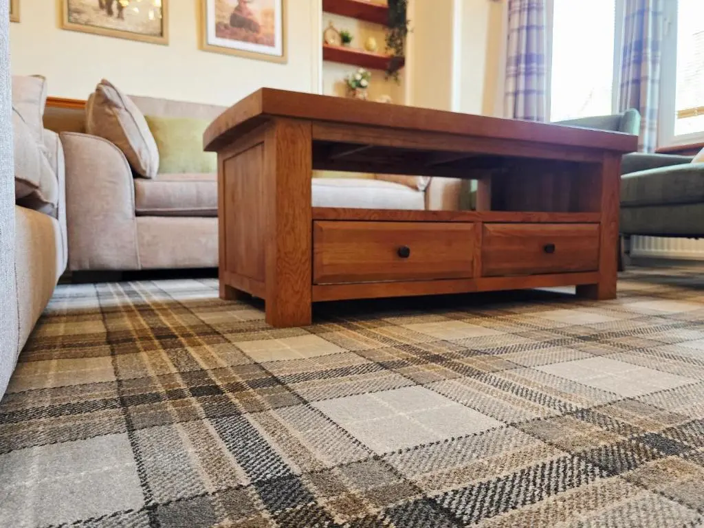 a living room with a coffee table and a couch at Inverness City 4 Bedroom house free parking in Inverness