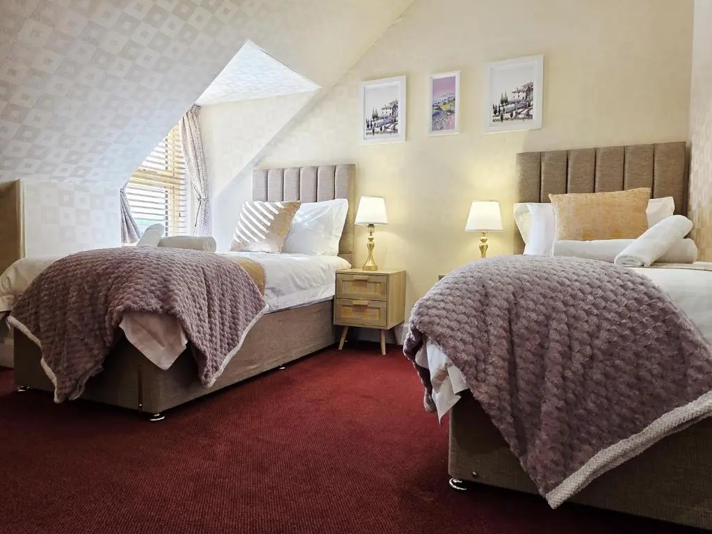a bedroom with two beds and a window at Inverness City 4 Bedroom house free parking in Inverness