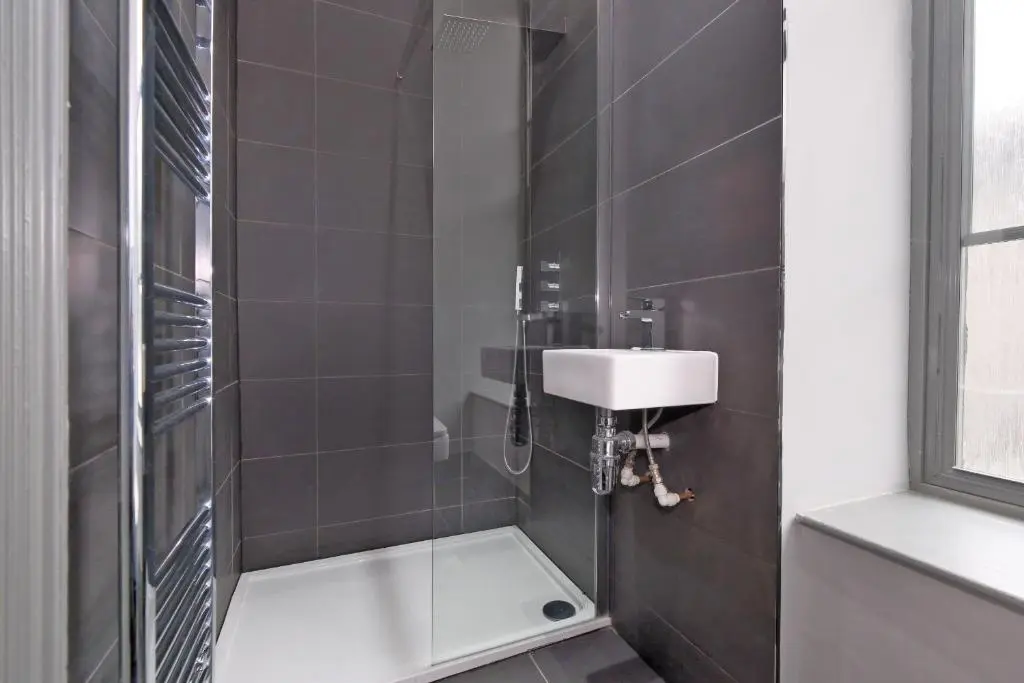 a bathroom with a sink and a shower at Kirkton House in Kirkton of Skene