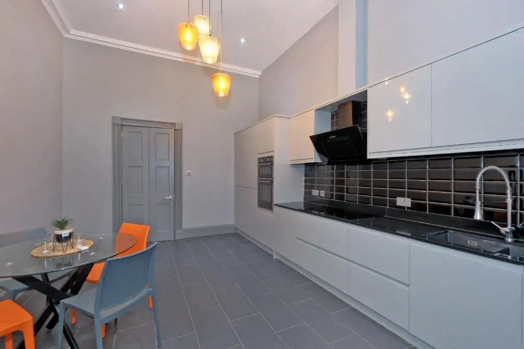 a kitchen with a table and a dining room at Kirkton House in Kirkton of Skene