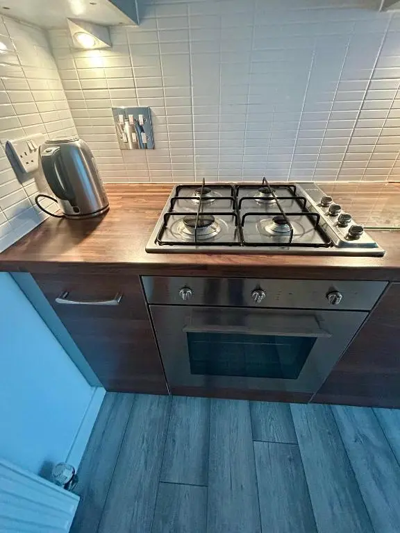 a kitchen counter with a stove and a phone at Luxury 2 bedroom apartment in Aberdeen in Kirkton of Skene