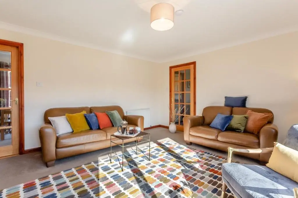 a living room with two couches and a table at 3 Bed in Strathkanaird oc-r30948 in Ullapool