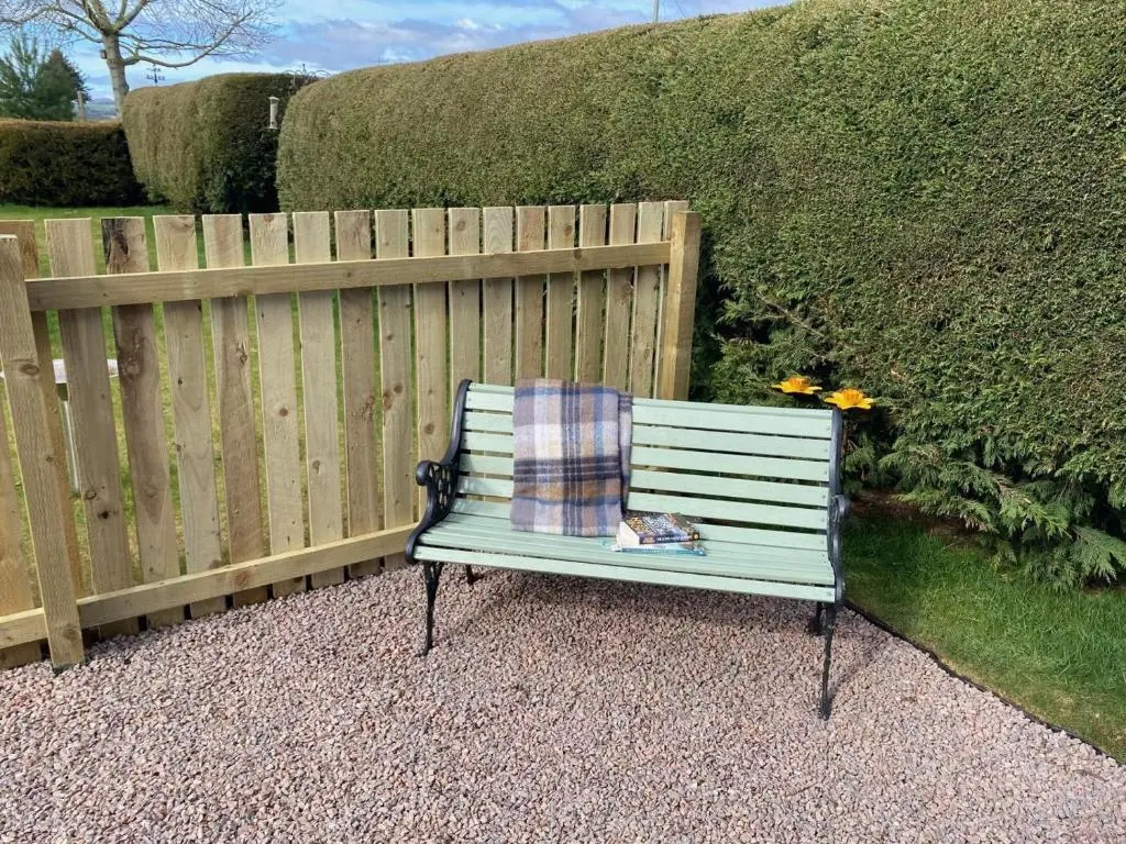 a bench with a pillow on it next to a fence at 2 Bed in Insch oc-t30986 in Colpy