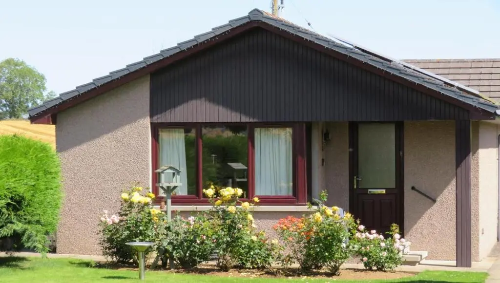 a small house with flowers in front of it at 2 Bed in Insch oc-t30986 in Colpy