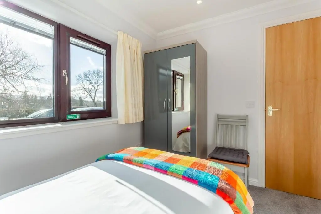 a bedroom with a bed with a colorful blanket on it at 2 Bed in Insch oc-t30986 in Colpy