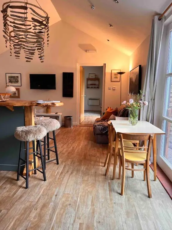 a living room with a table and chairs at The Space at the Creamery - Royal Deeside in Torphins