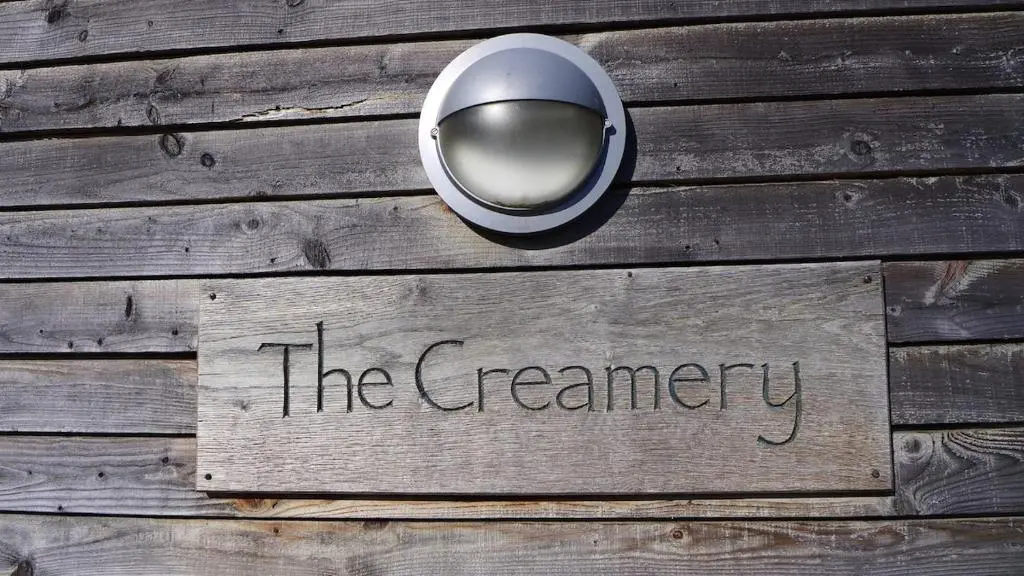a sign that says the ceremony on a wooden floor at The Space at the Creamery - Royal Deeside in Torphins