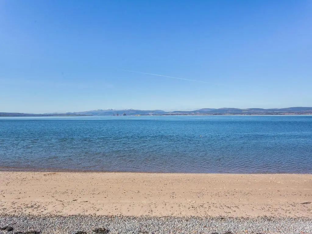 a beach with a large body of water at Harbour View in Cromarty
