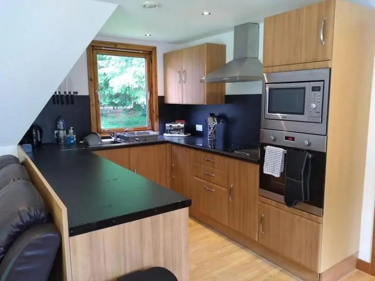 a kitchen with a counter top and a microwave at True North Lodge - A cosy wee highland Getaway in Spean Bridge