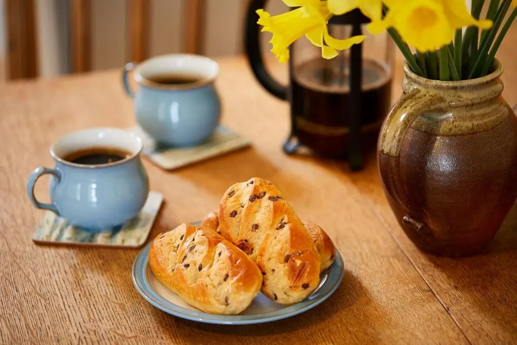 a table with two plates of bread and two cups of coffee at Fishermans Rest in Lossiemouth