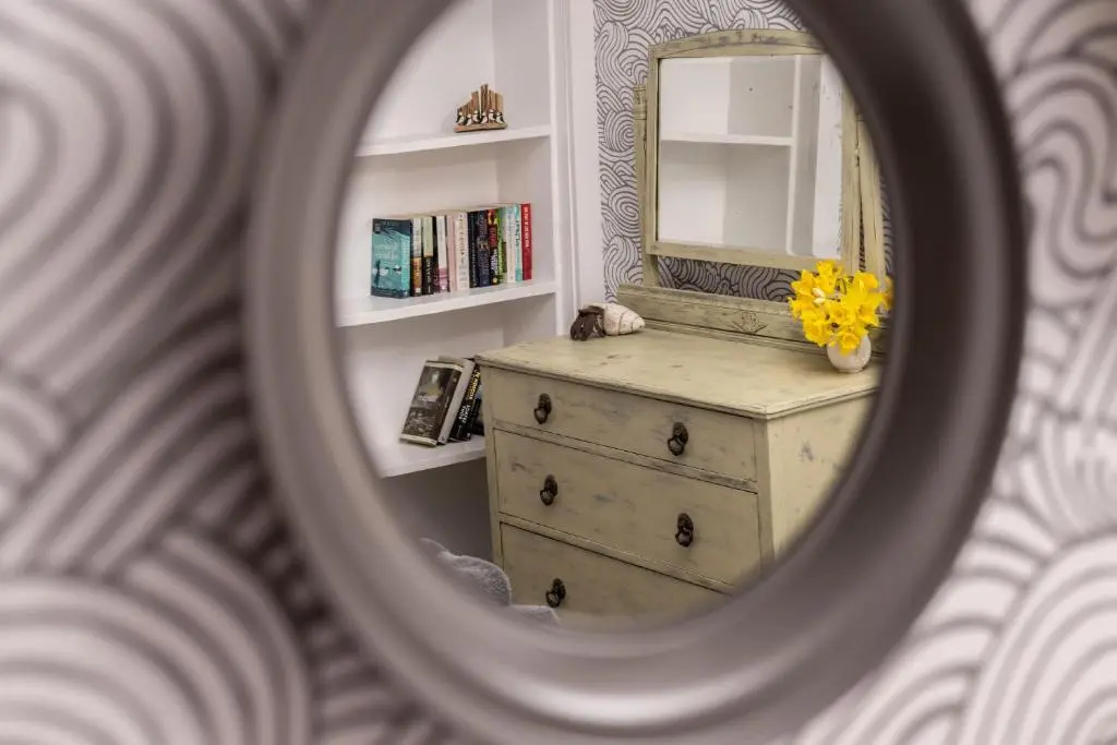 a mirror reflection of a dresser in a bathroom at Fishermans Rest in Lossiemouth