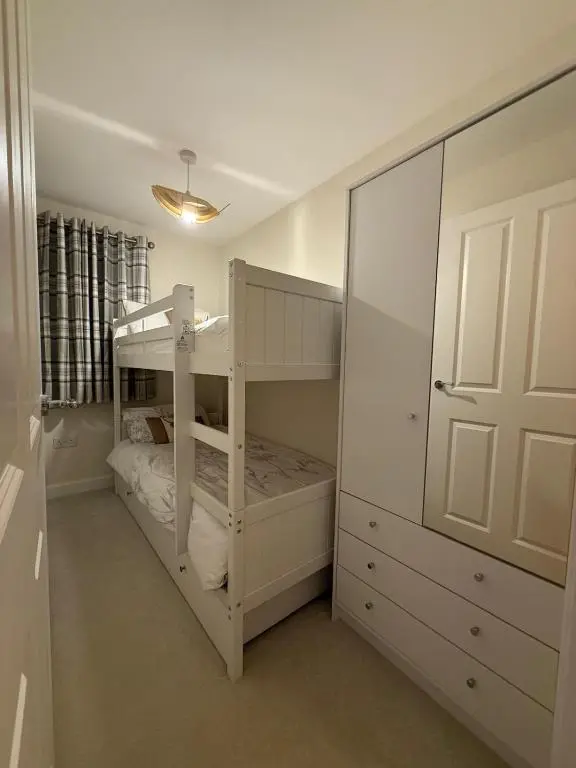 a bedroom with two bunk beds and a closet at Loch Ness Hideaway in Inverness