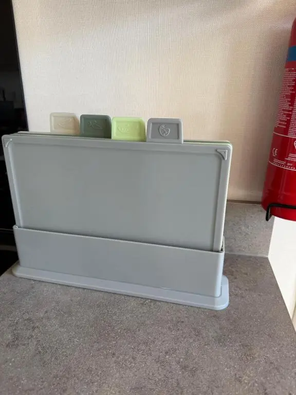 a white drawer with four different colored candles in it at Agnes Place in Nairn