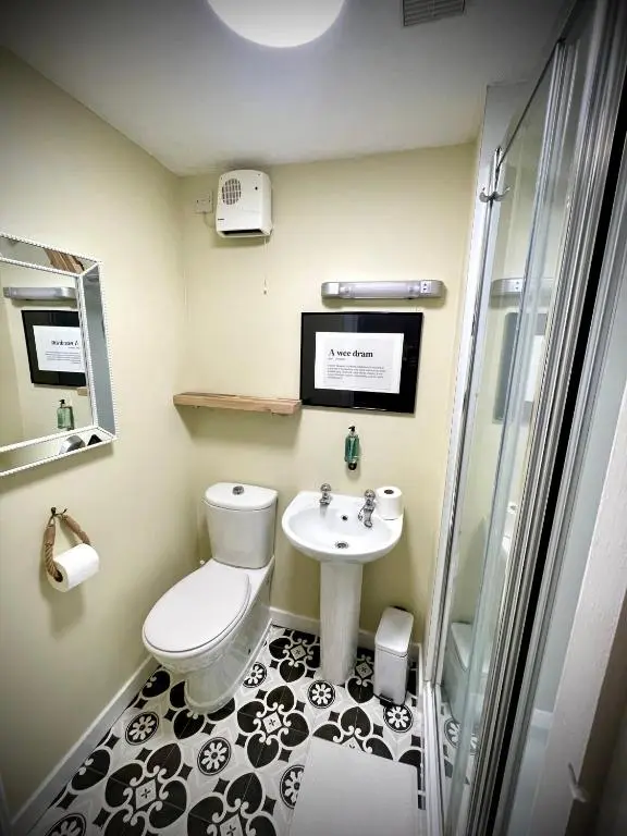a bathroom with a toilet and a sink at Stag and Barrel in Elgin